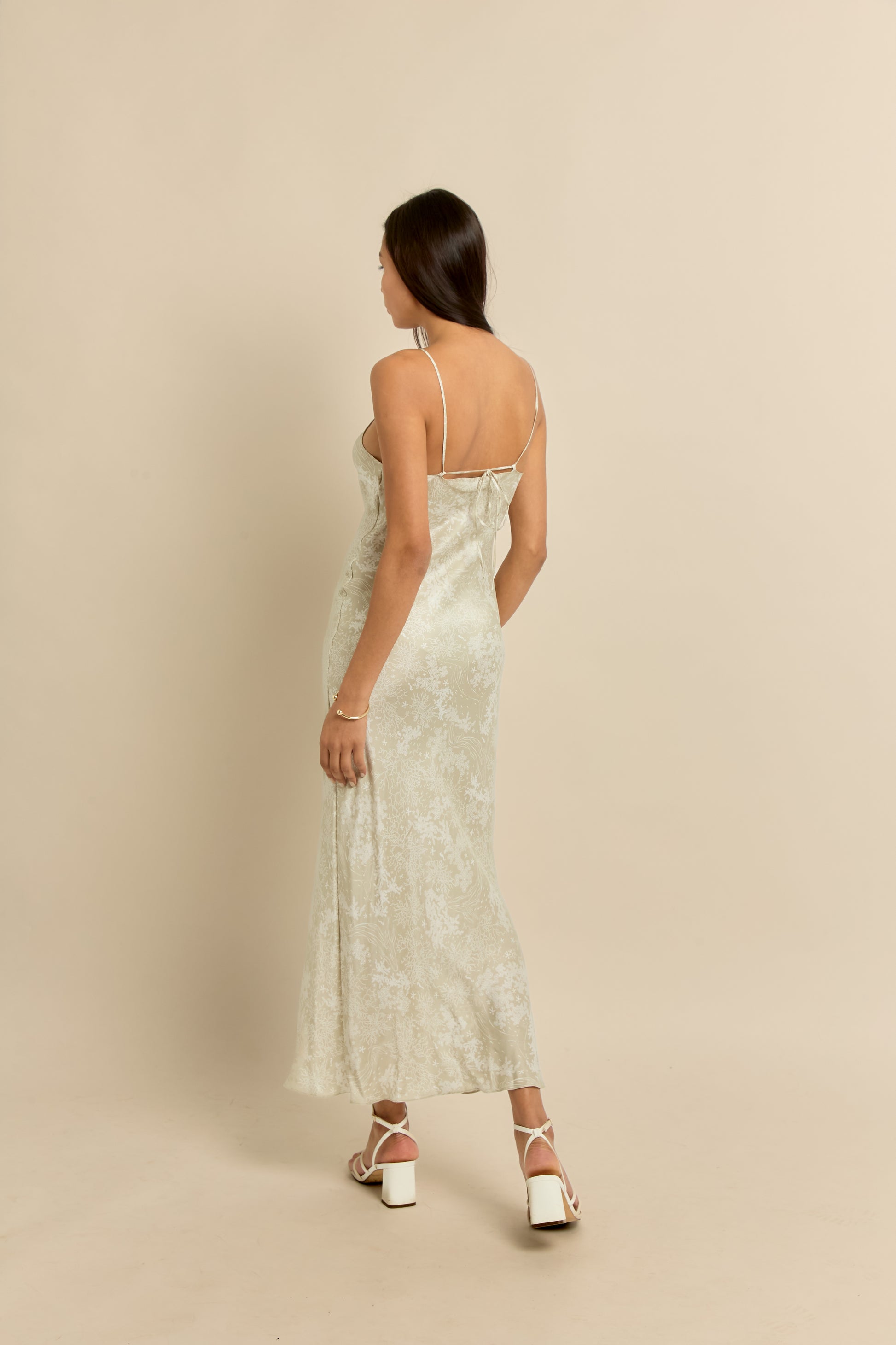 Midi silk slip dress in beige with a subtle floral and coral print.