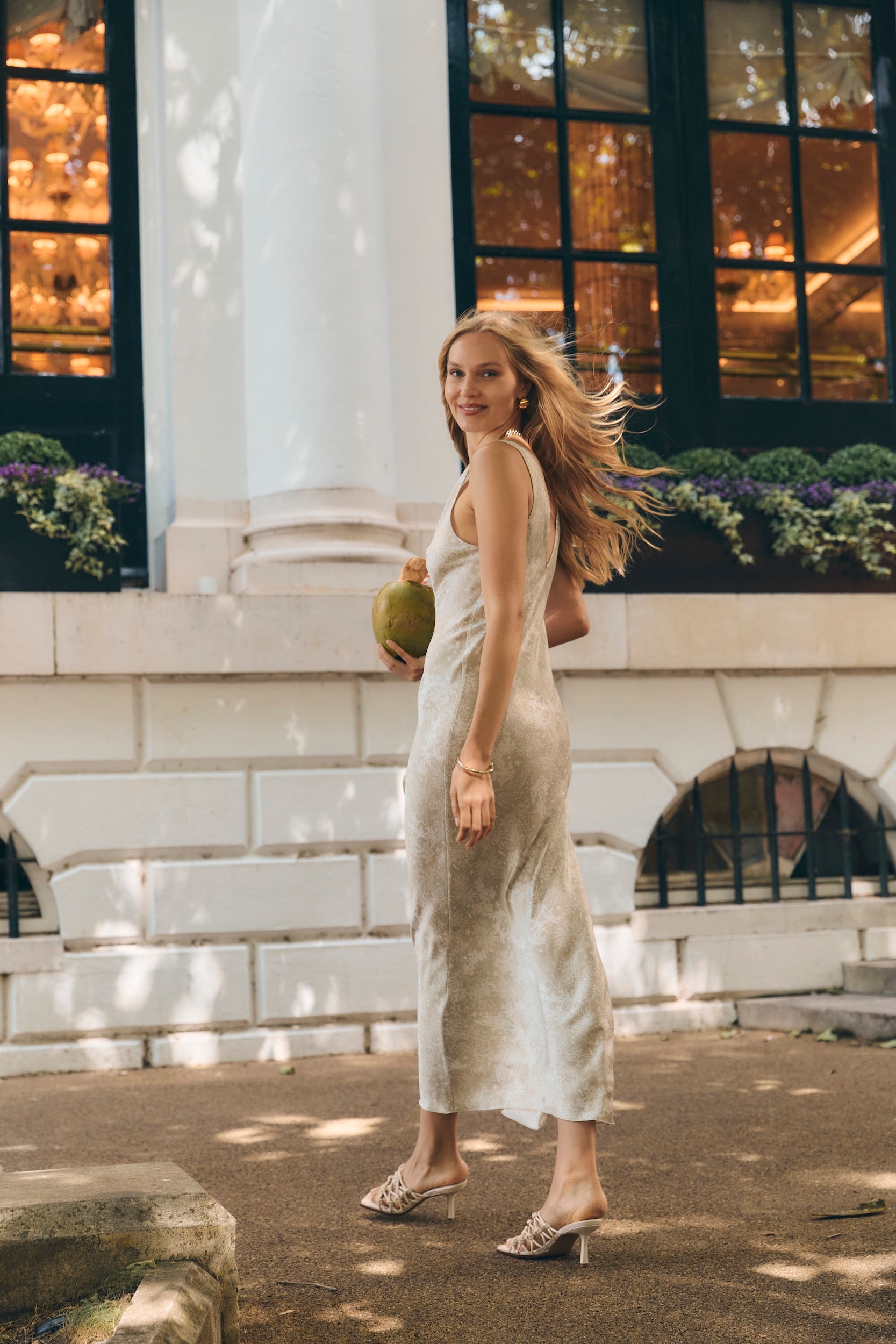 Woman in light silk slip dress on vacation