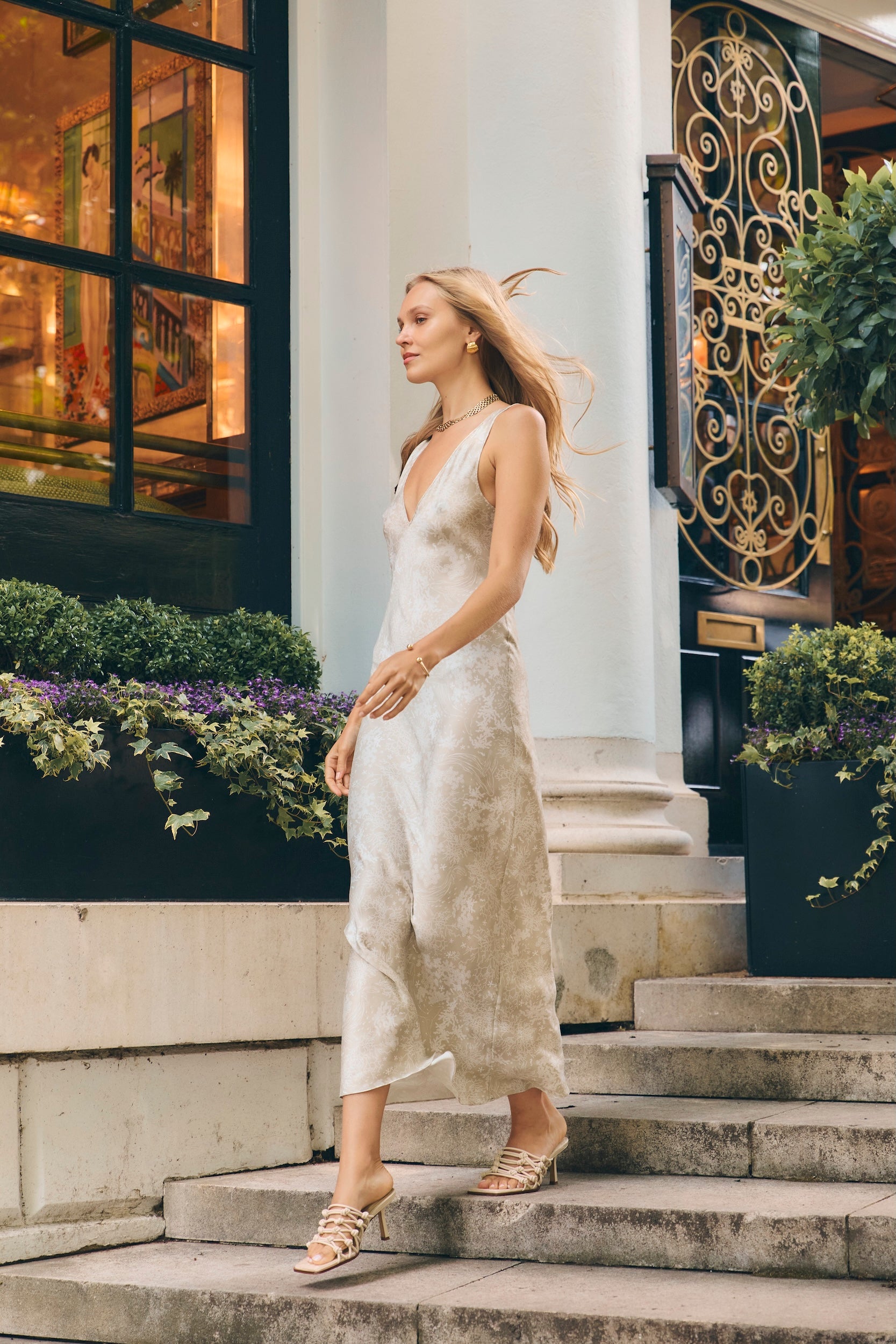 Woman in V neck silk slip dress at an event